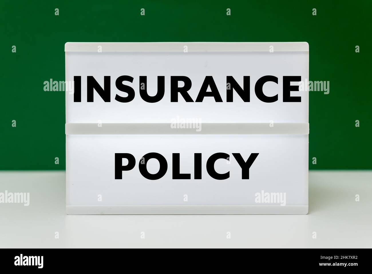 Insurance Policy text on green background Stock Photo