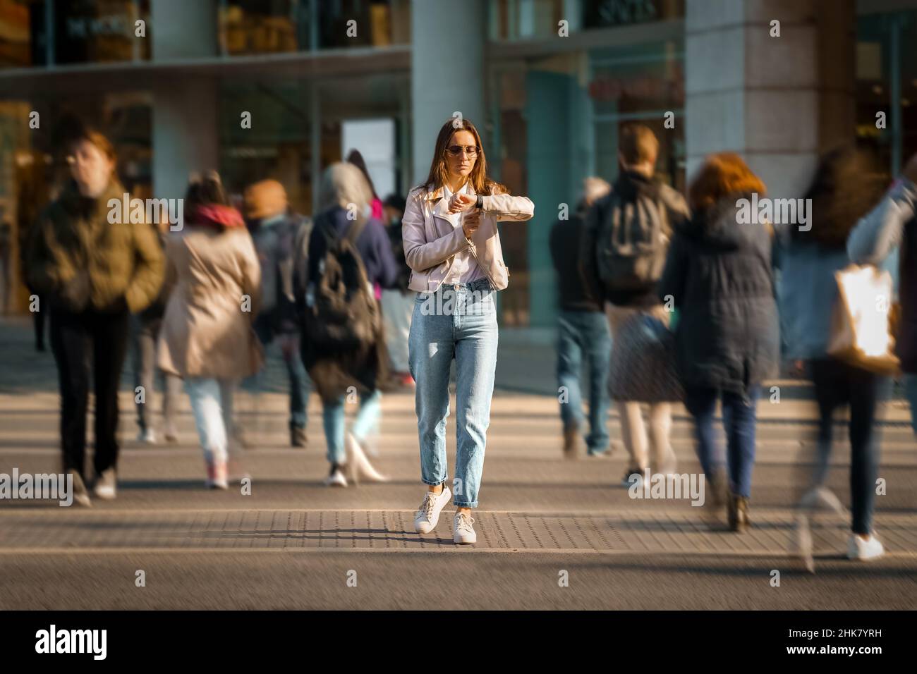 Woman walking crowded street hi-res stock photography and images - Alamy