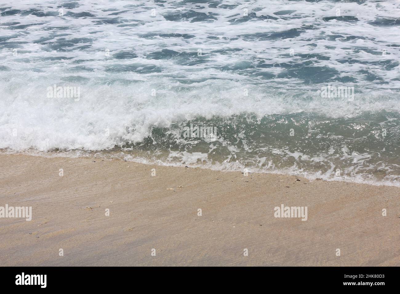 background of waves and foam on the beach Stock Photo