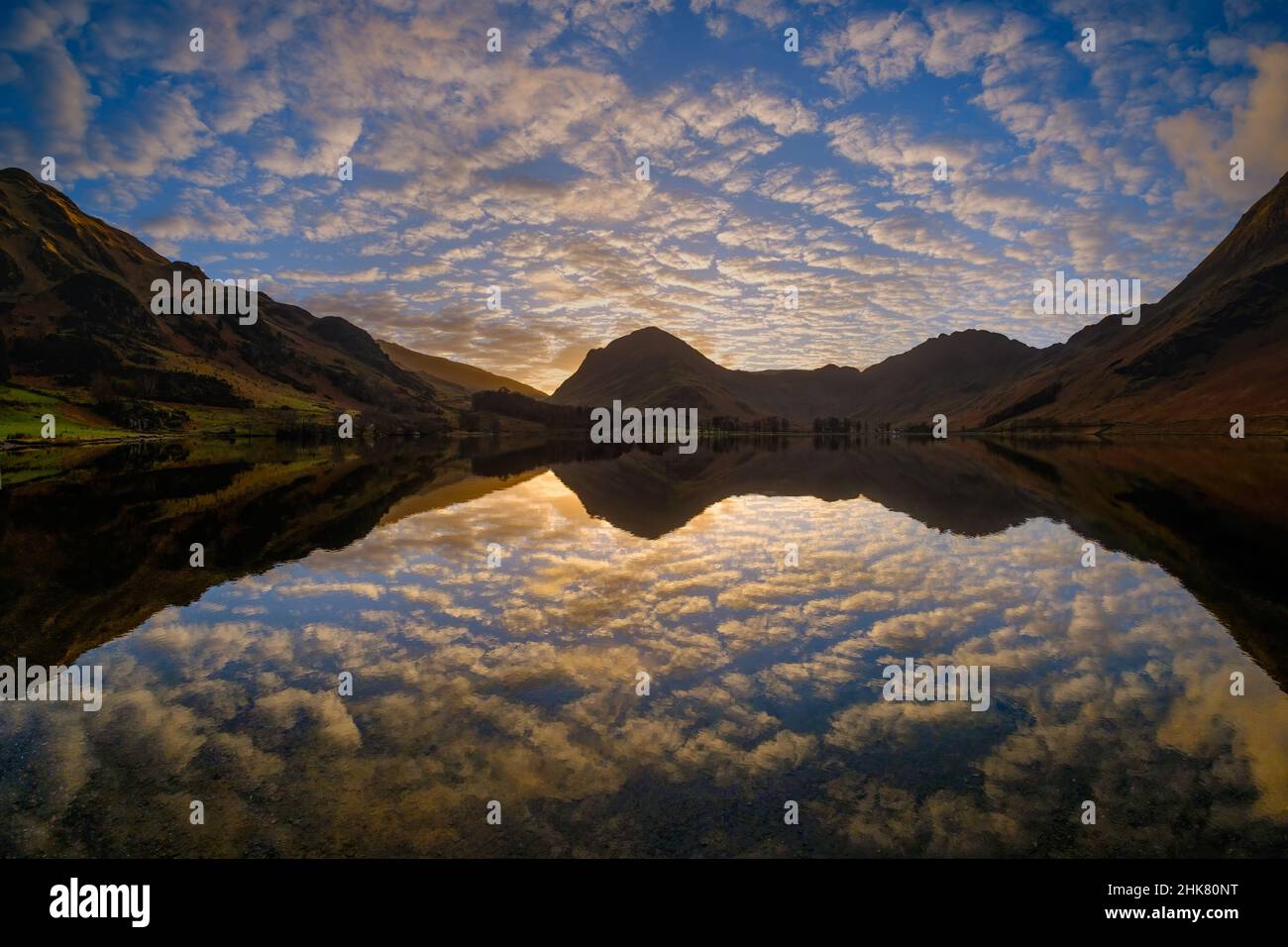 Early morning light shortly after sunrise, reflecting off clouds over Buttermere in the Lake District, UK Stock Photo