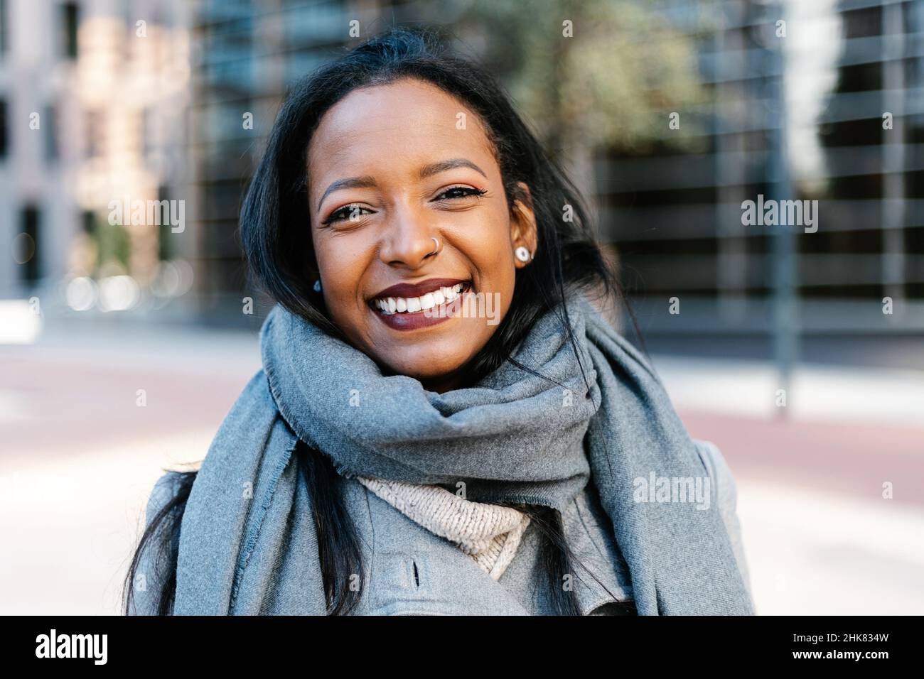 Portrait of joyful young hispanic latina woman smiling at camera  Stock Photo