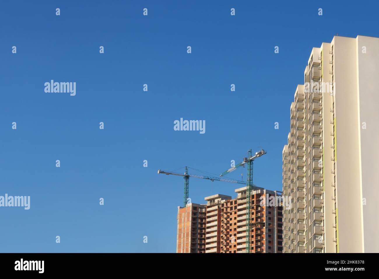 Multistory house. Tower cranes construction site building company property background real estate mortgage loan. Investment building apartments Stock Photo
