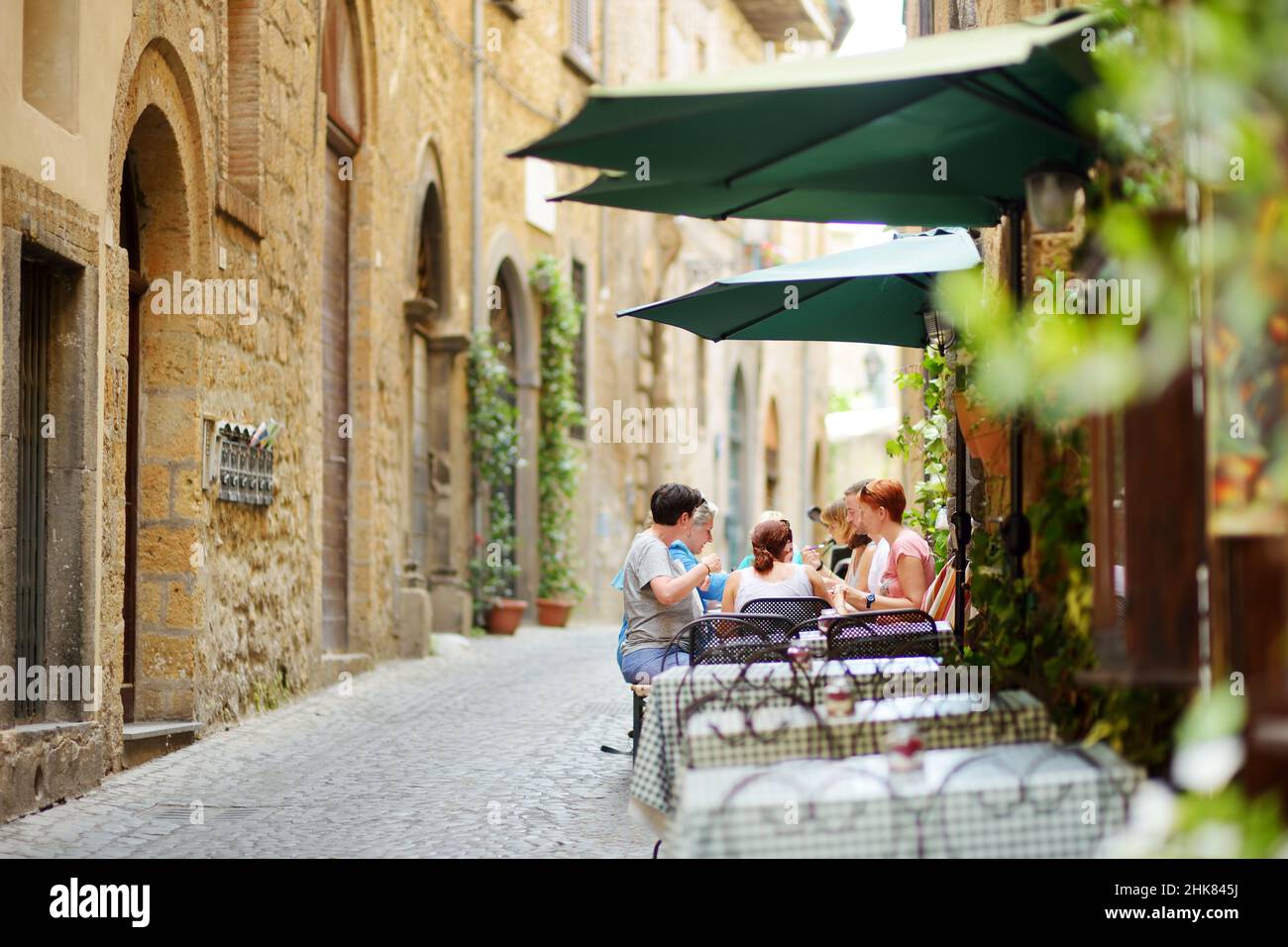 ORVIETO, ITALY - JUNE 11, 2019: Streets of the famous Orvieto, a medieval hill town, rising above the almost-vertical faces of tuff cliffs and surroun Stock Photo