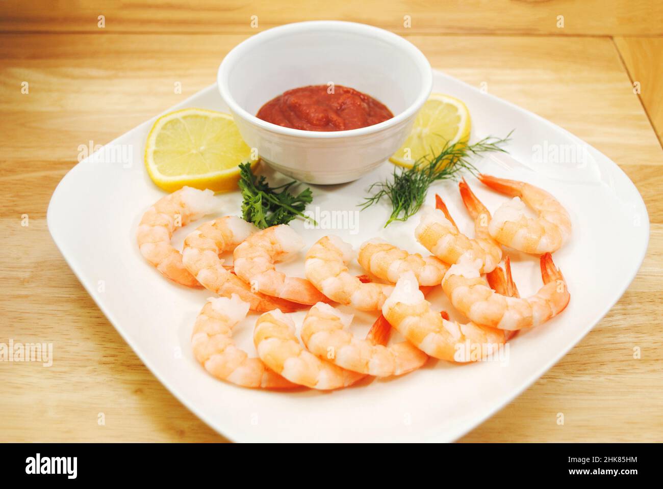 Appetizer of Fresh Cooked Shrimp with Sliced Lemon, cocktail Sauce, Dill, and Parsley Stock Photo