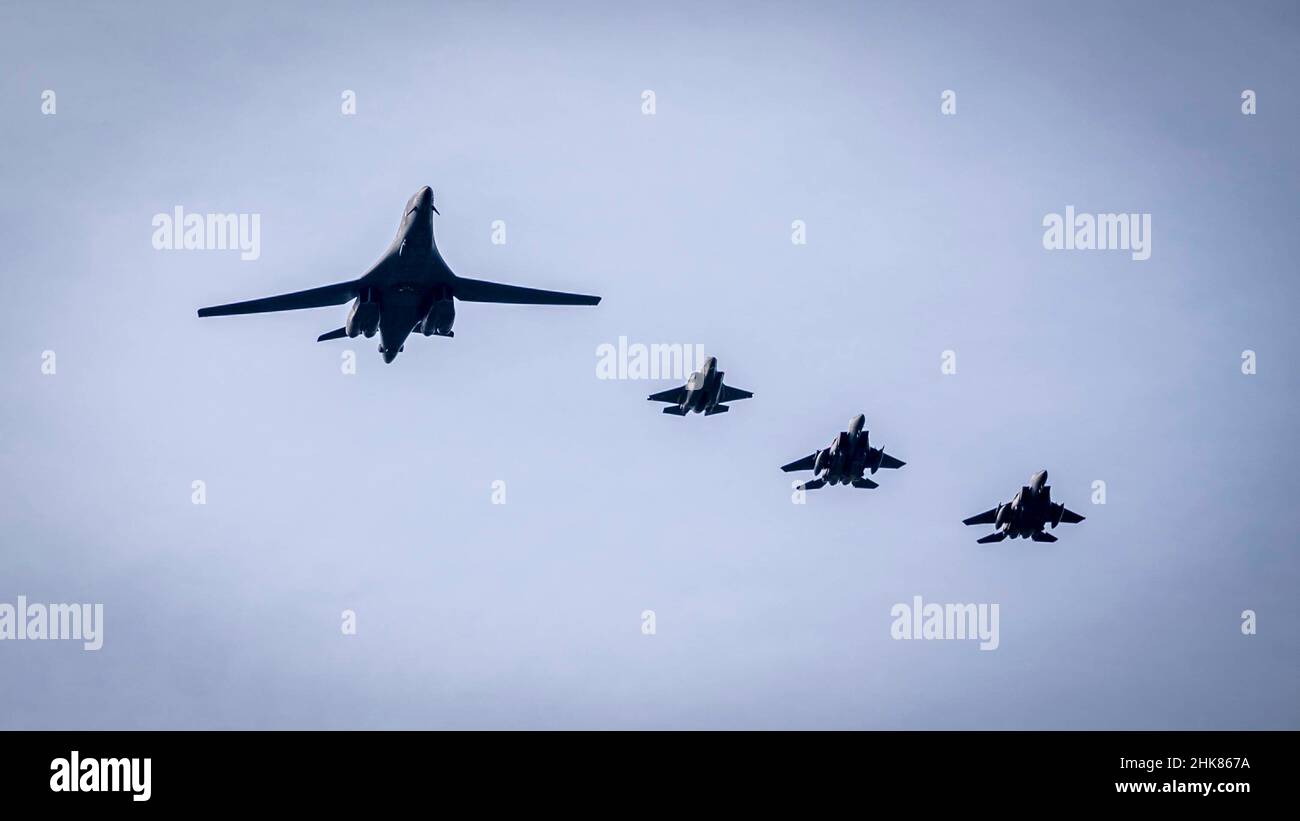 A U.S. Air Force B-1B Lancer assigned to 28th Bomb Wing and two F-15E Strike Eagles assigned to the 492nd and 494th Fighter Squadrons as well as a Royal Air Force F-35B Lightning conduct a flyover at Royal Air Force Lakenheath, England, Feb. 1, 2022. The aircraft participated in a long-distance round trip flight from the U.S. to the United Kingdom to commemorate the 80th anniversary of the 8th Air Force. (U.S. Air Force photo by Senior Airman Koby I. Saunders) Stock Photo