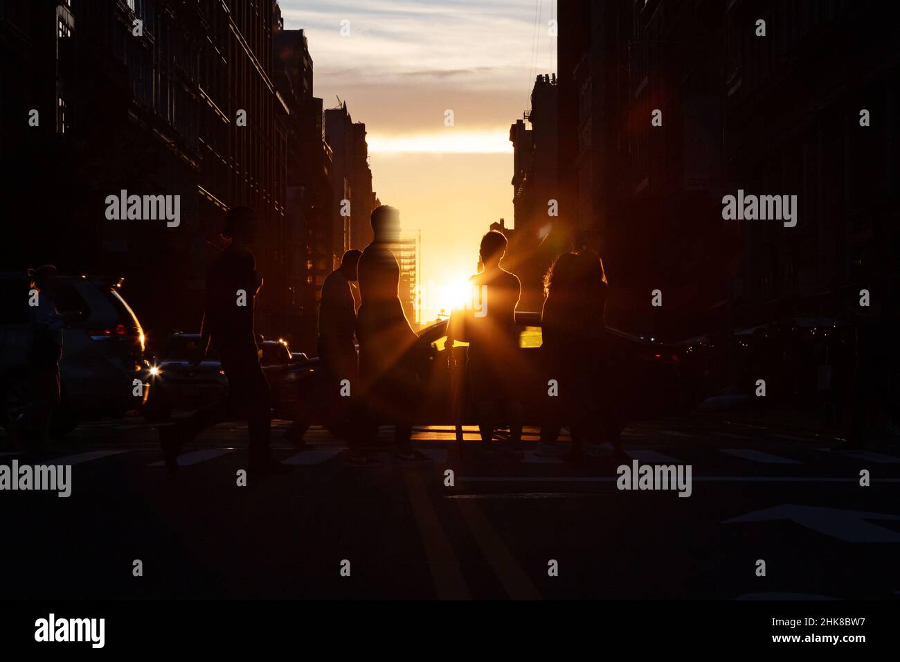Busy street scene with crowds of people and cars in an intersection on ...
