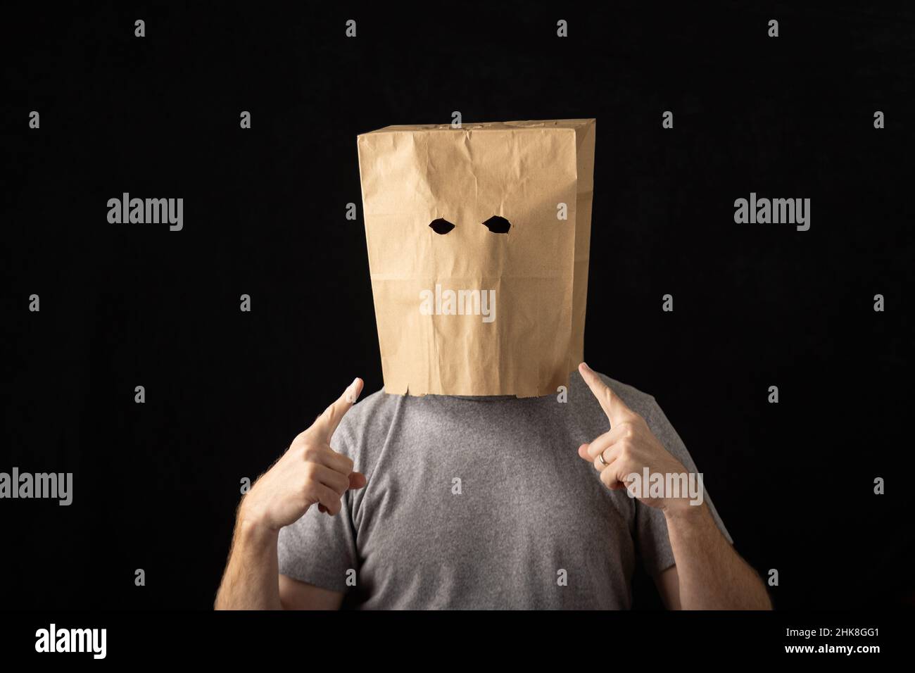 Man wearing a brown paper bag over his head and pointing at himself Stock Photo Alamy