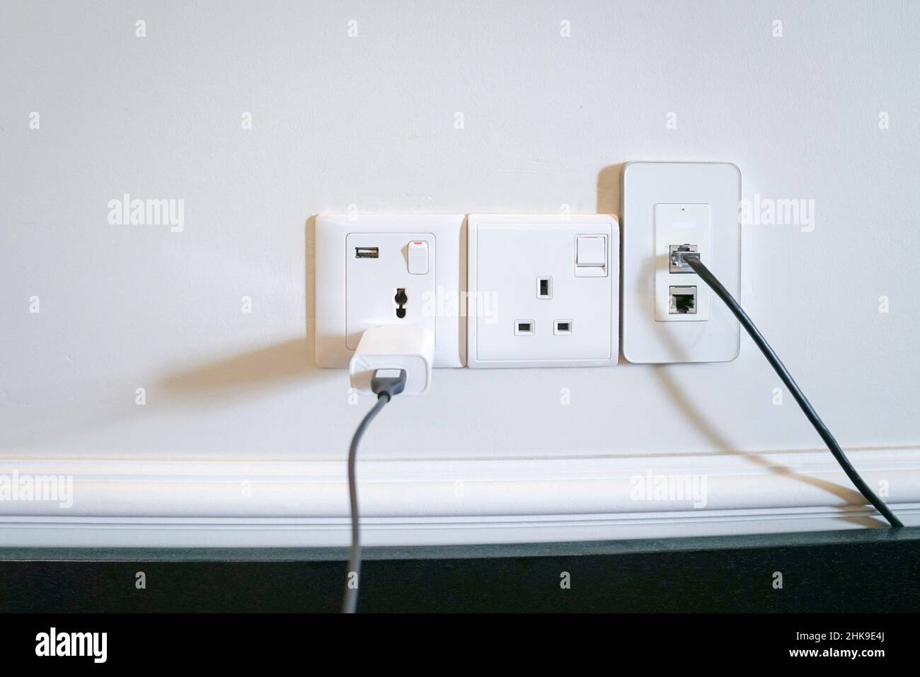 Electric power outlets on the wall with data and charging cable