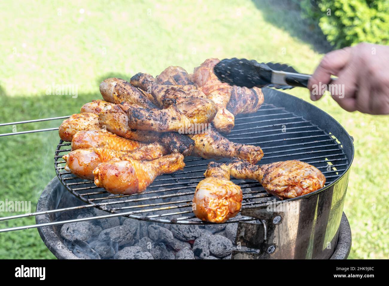 Cooking barbecue chicken wings coal on grill glowing coals bbq in the garden. Stock Photo