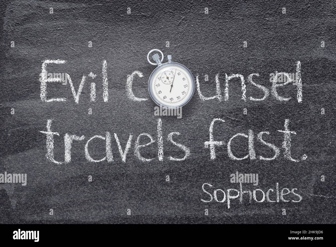 Evil counsel travels fast - quote of ancient Greek philosopher Sophocles written on chalkboard with vintage stopwatch Stock Photo