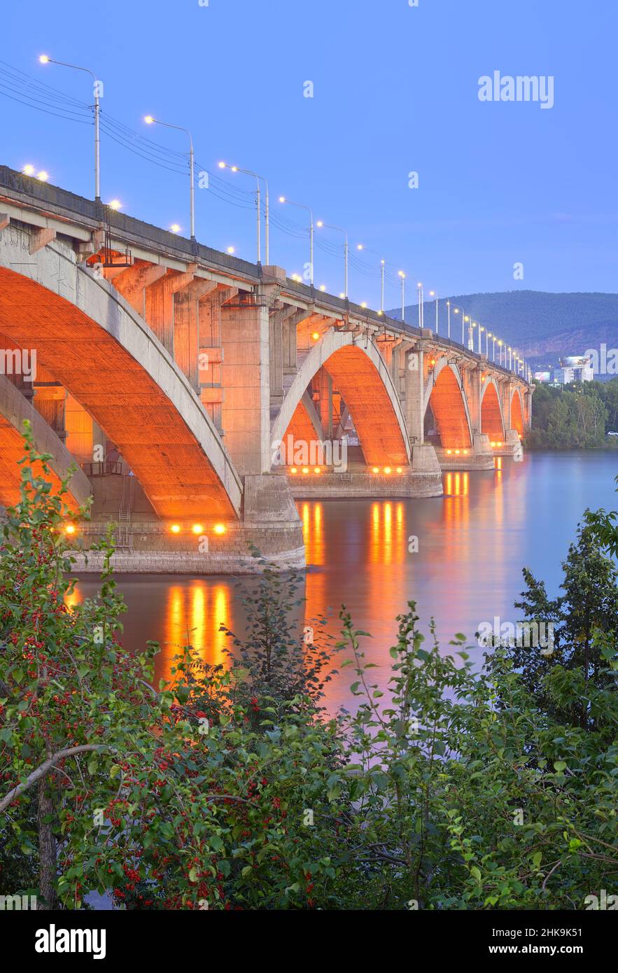 Arched structure in the evening lights on the Central embankment of the Yenisei River. Siberia, Russia Stock Photo