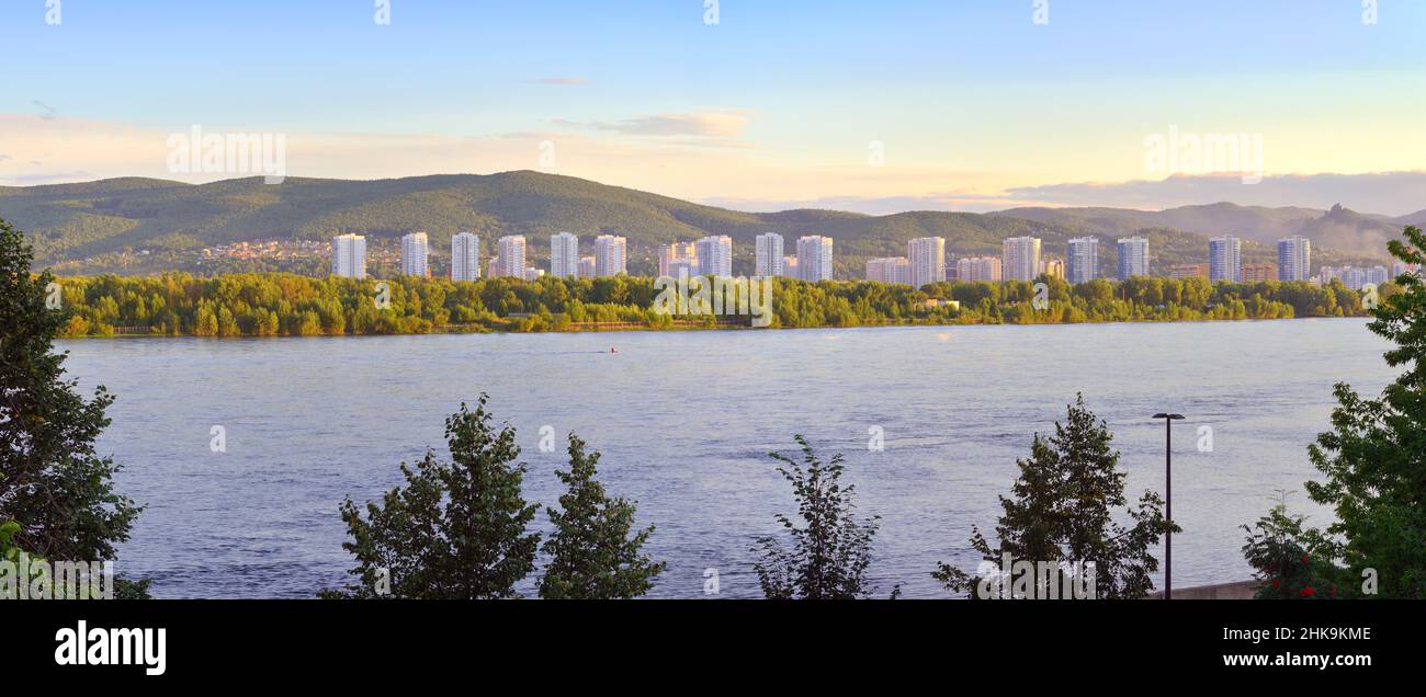 Panorama of the Yaryginskaya embankment development on the bank of the Yenisei River against the background of green hills. Siberia, Russia Stock Photo