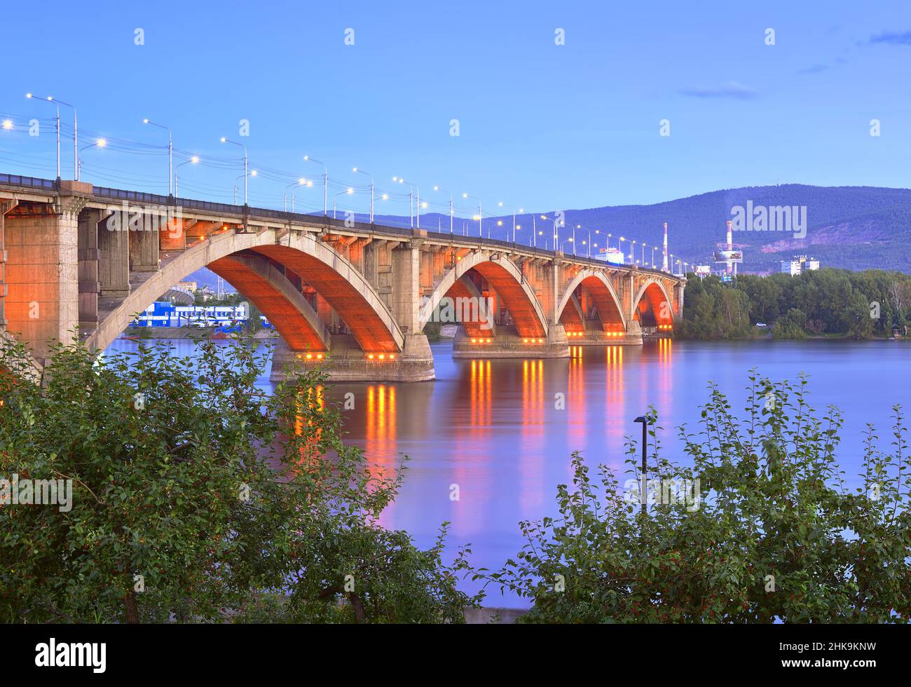 Arched structure in the evening lights on the Central embankment of the Yenisei River. Siberia, Russia Stock Photo