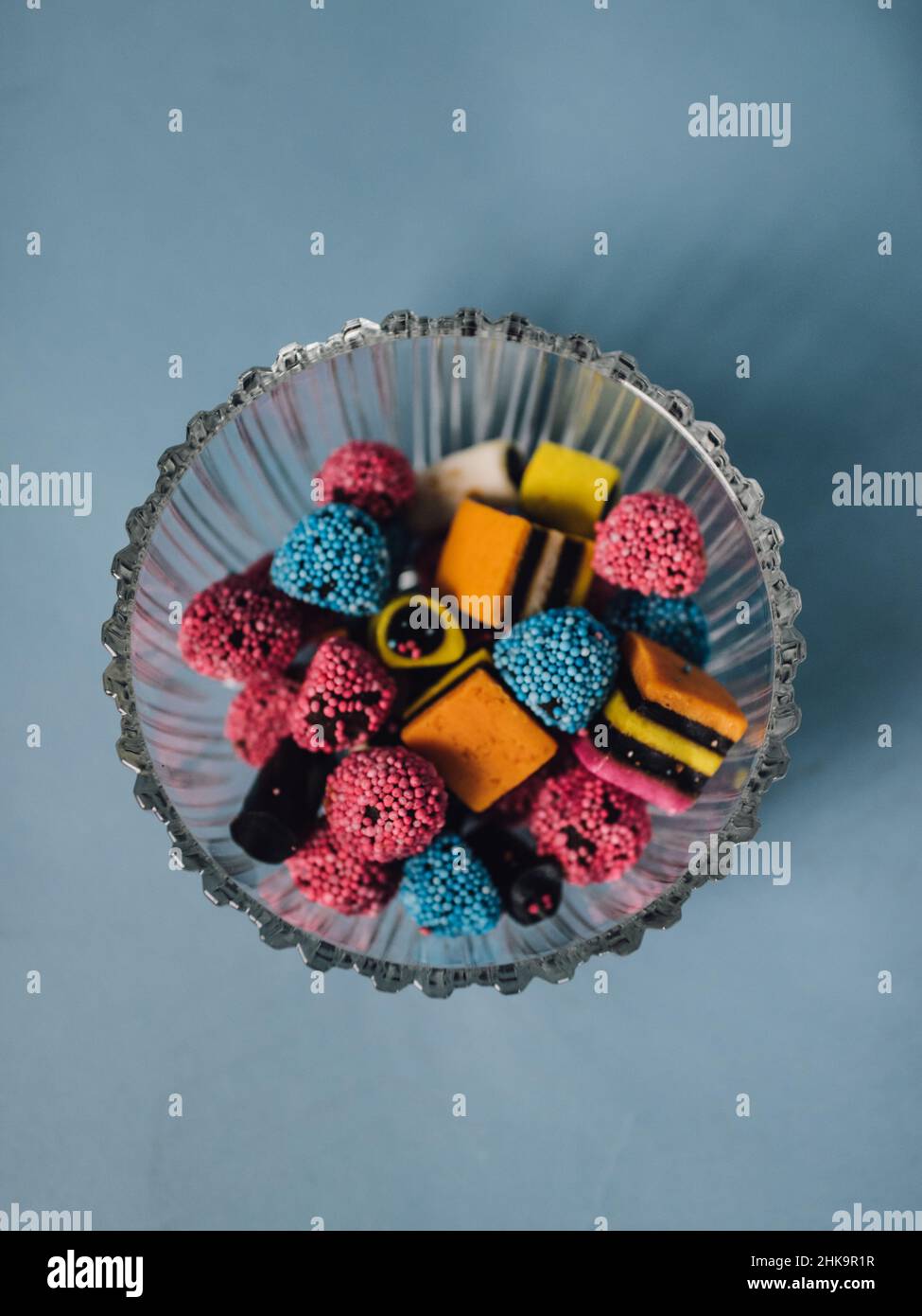 British licorice allsorts candy in crystal bowl with light blue background Stock Photo