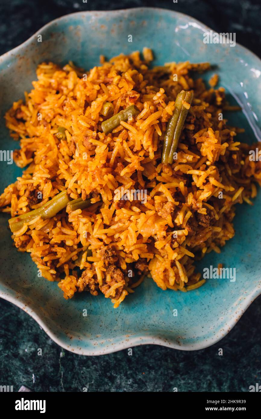 Lubia polo Persian rice dish with ground beef, green beans, turmeric Stock Photo