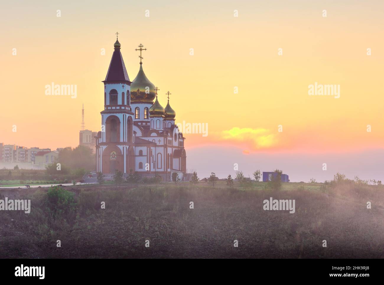 Orthodox church on the outskirts of the city in the morning fog at dawn. Krasnoyarsk, Siberia, Russia Stock Photo