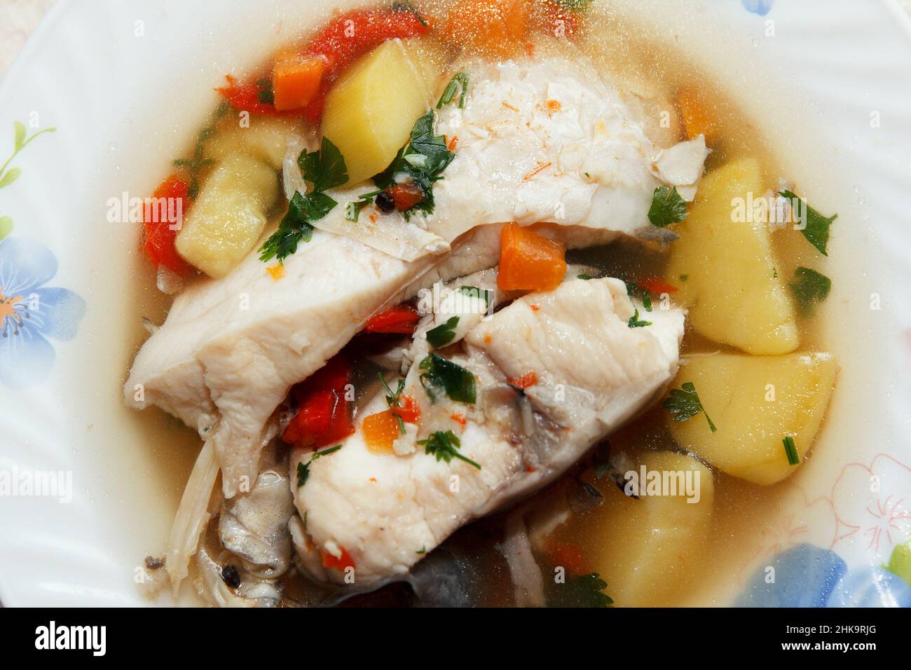 Traditional delicious savory fish soup served hot on a plate for lunch ...