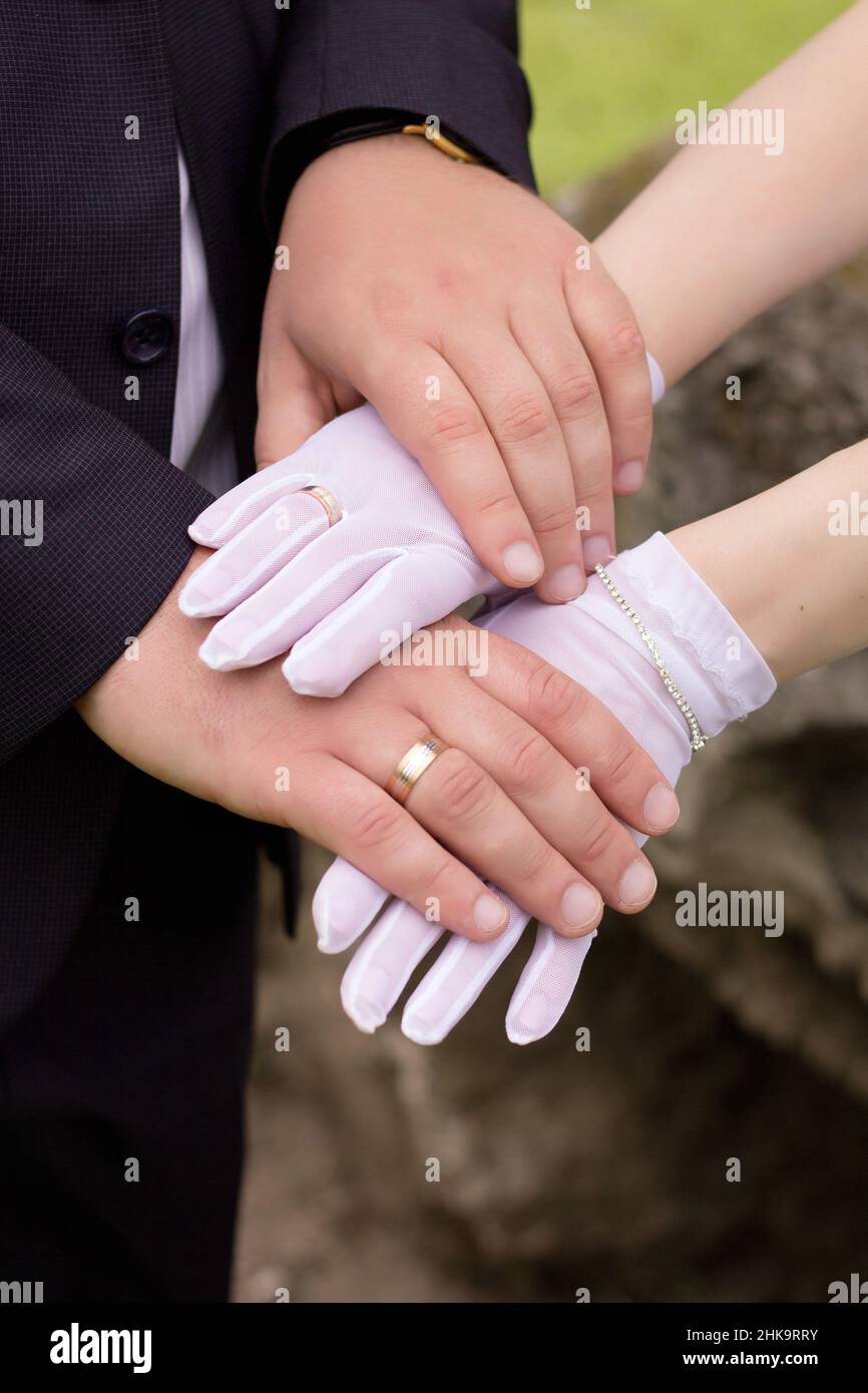 Hands of newlyweds, gold rings and wedding union Stock Photo