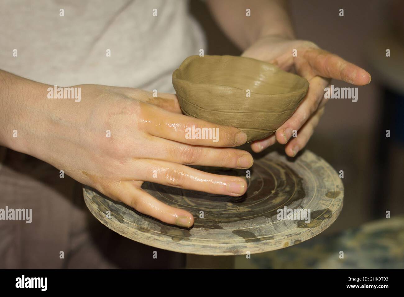 Potter master on a wheel makes products of clay Stock Photo Alamy