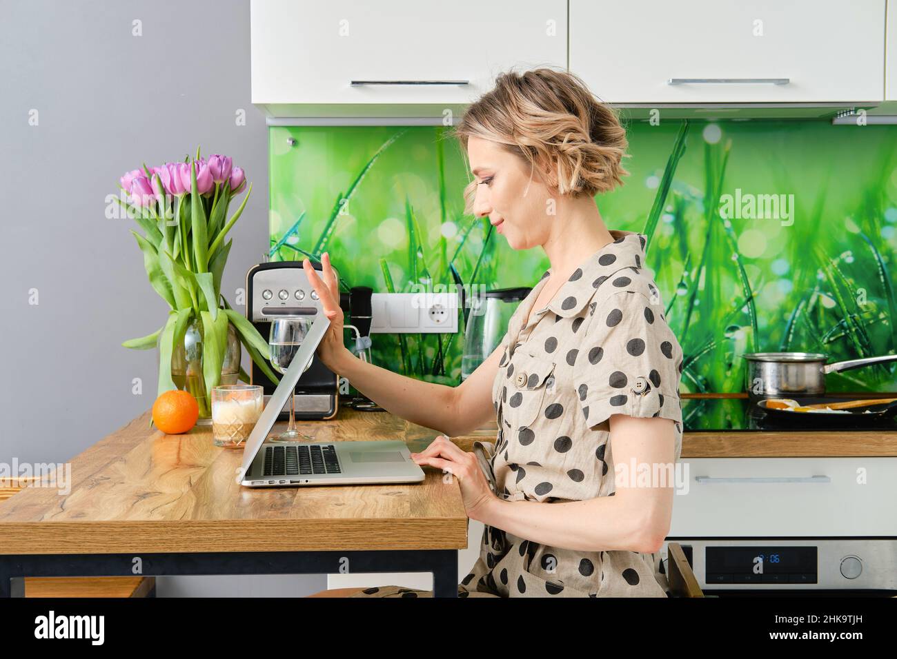 Serious young woman starts working day at home office, she is opening