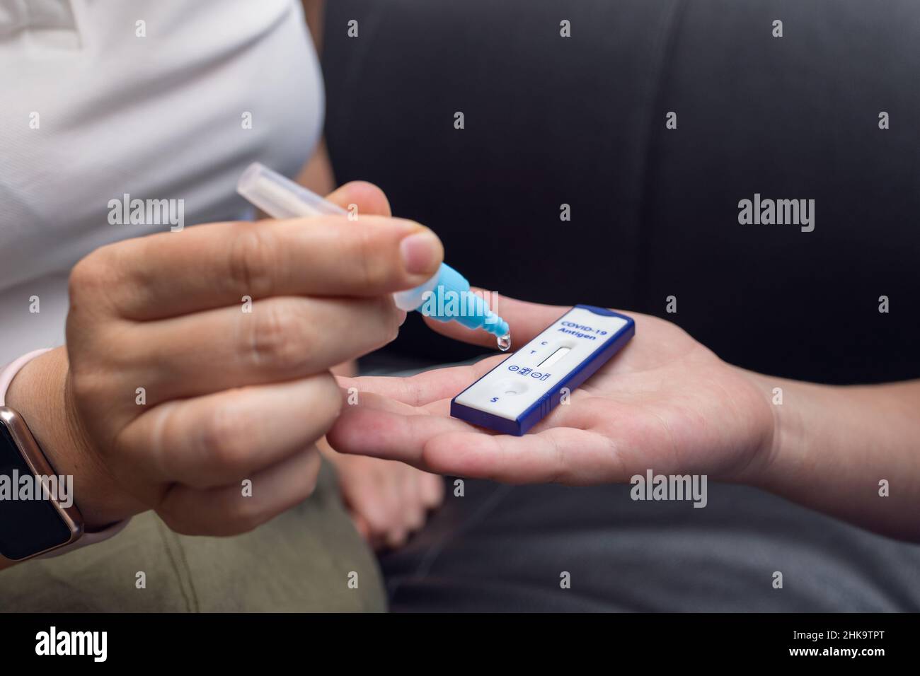 Mother doing the COVID-19 rapid antigen test for her son Stock Photo