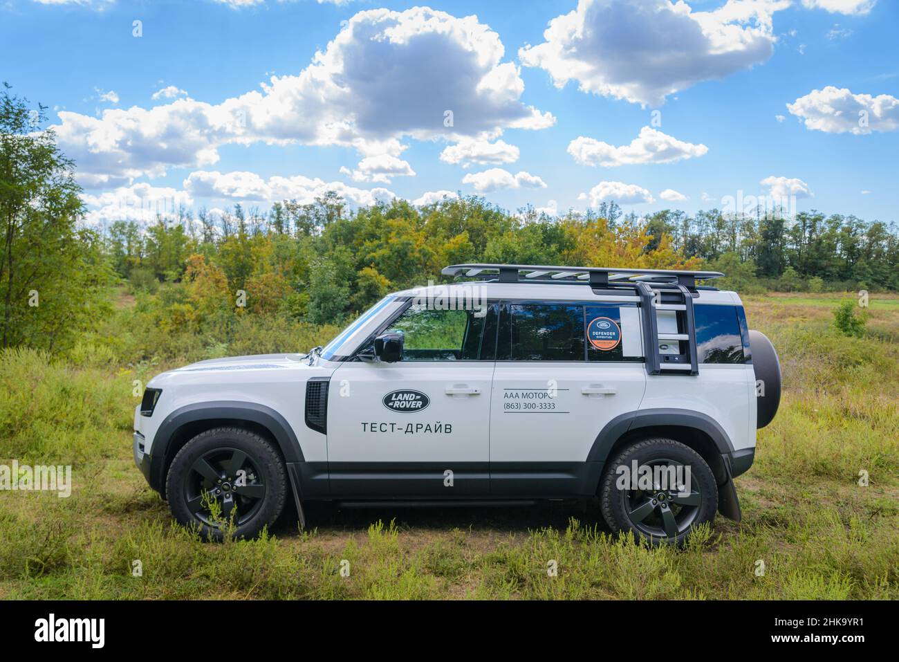 Russia, Rostovskaya oblast, 2021 June 09: Modern new SUV car Land Rover Defender, test drive in a field. Offroad 4x4 driving in wild. Stock Photo
