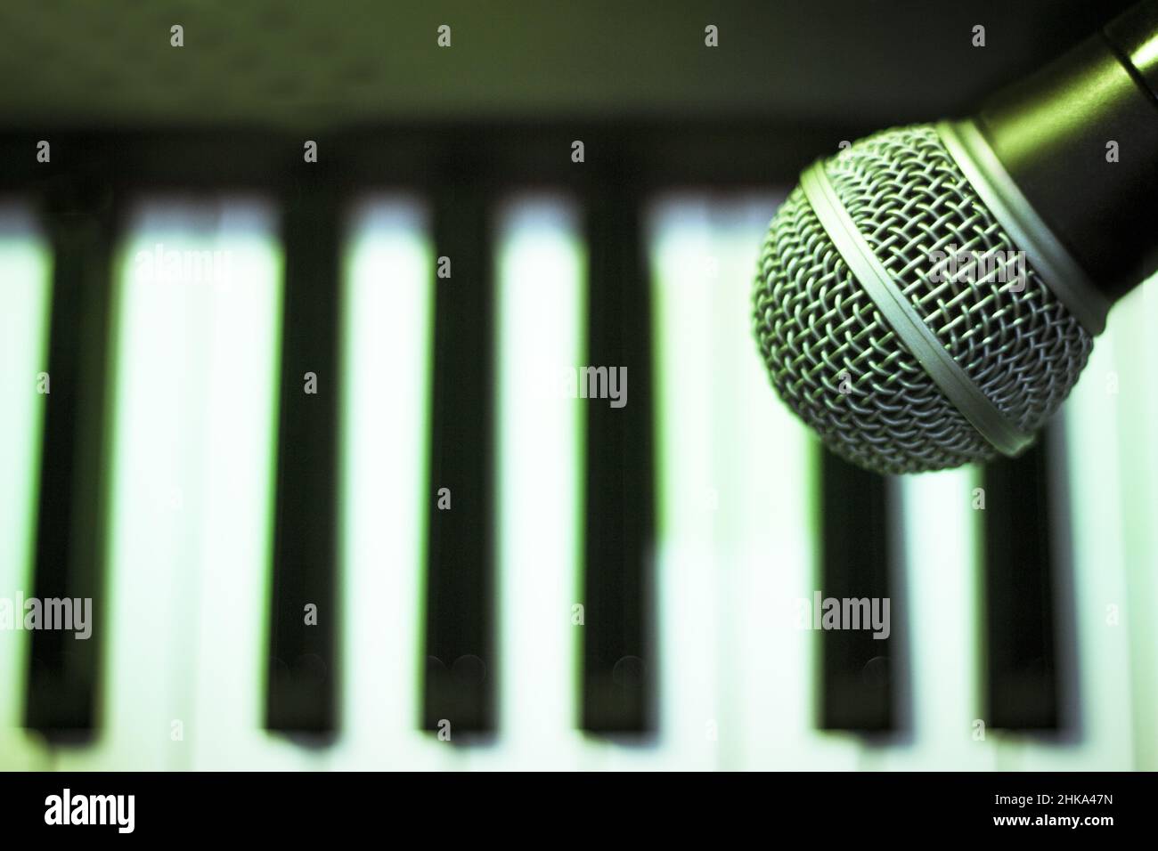 Microphone over piano keys in dim light. No people Stock Photo - Alamy