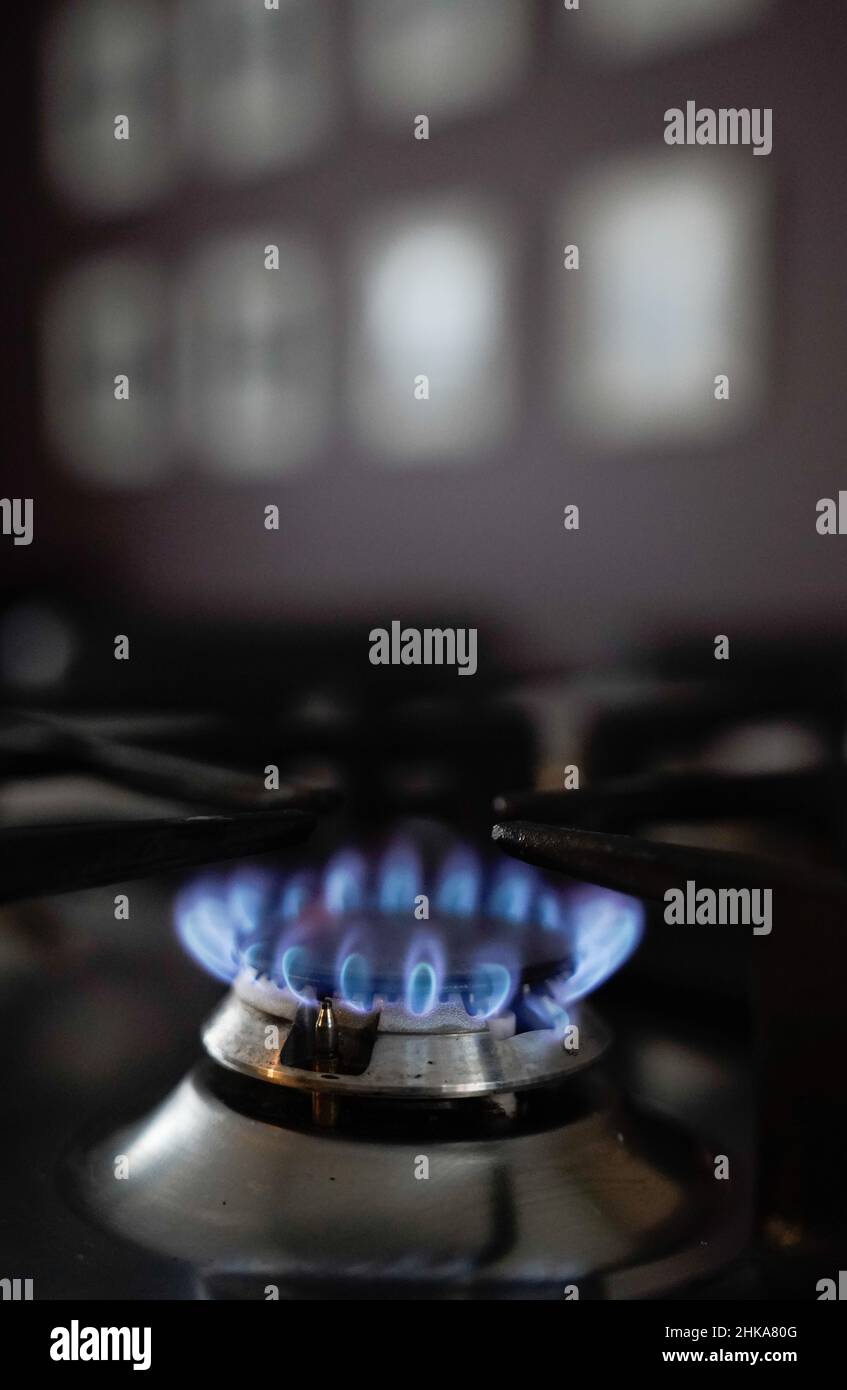 General view of a gas hob burning on a stove in a kitchen in