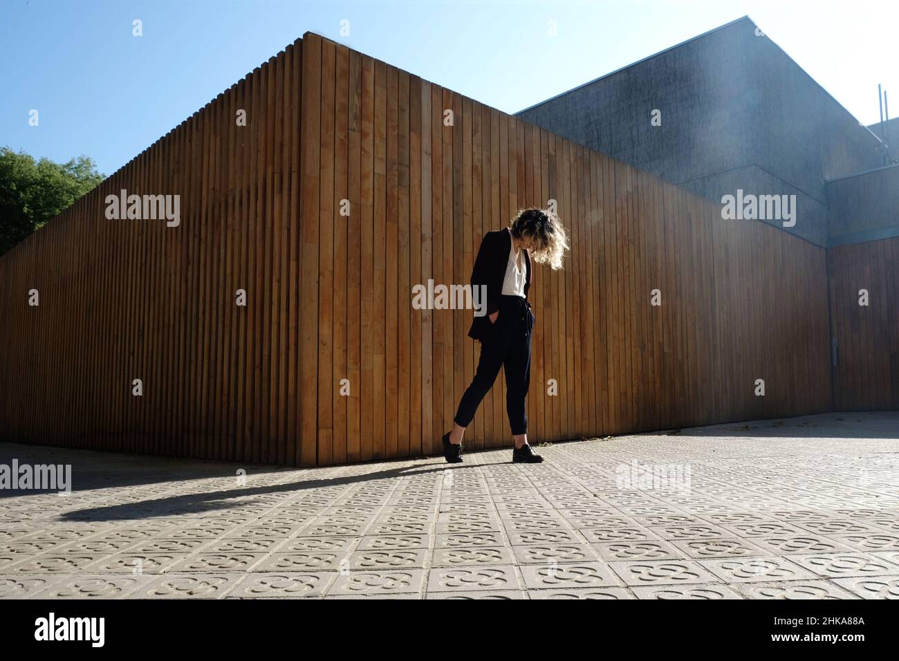 Young stylish woman walking on the city street Stock Photo