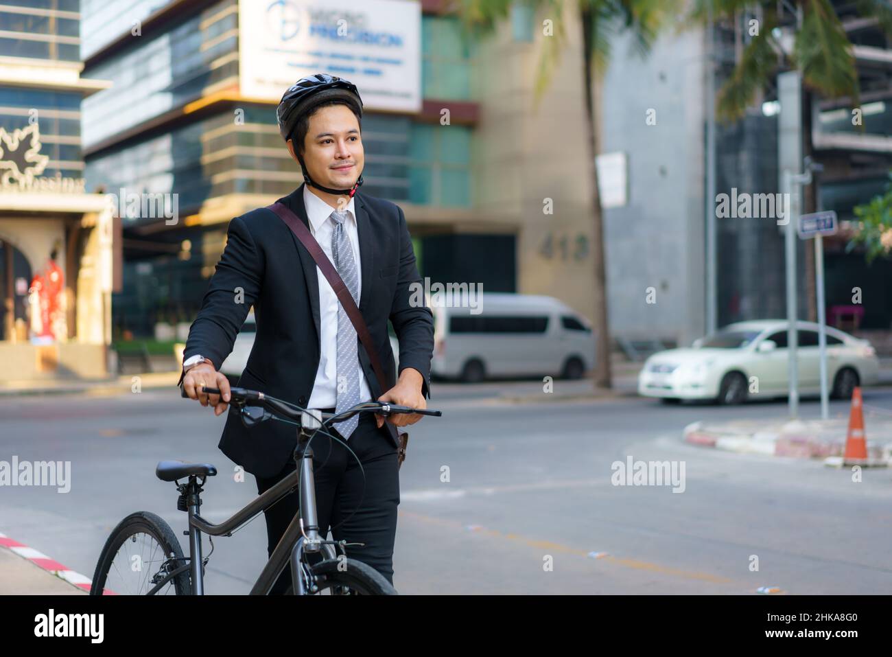 Asian businessman pushing his bicycle from home in the morning preparing to ride his bicycle to work. Eco tranportation. Stock Photo