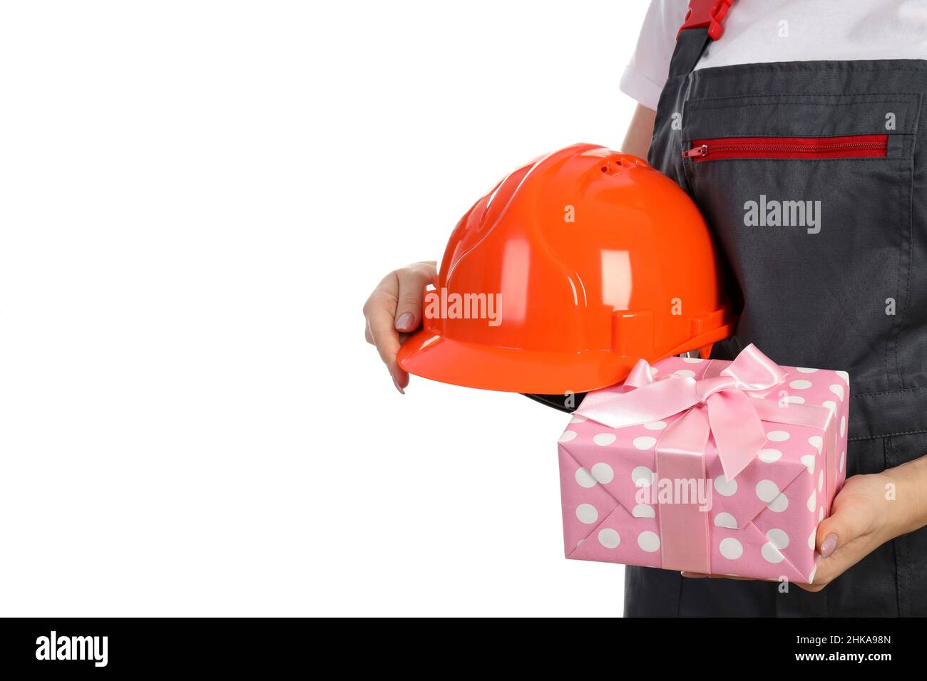 Builder woman with gift box and safety hat isolated on white background Stock Photo