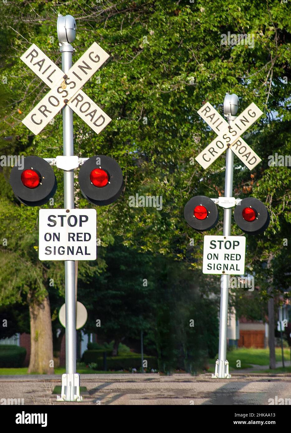 Red flashing multi Railroad track crossing signals Stock Photo