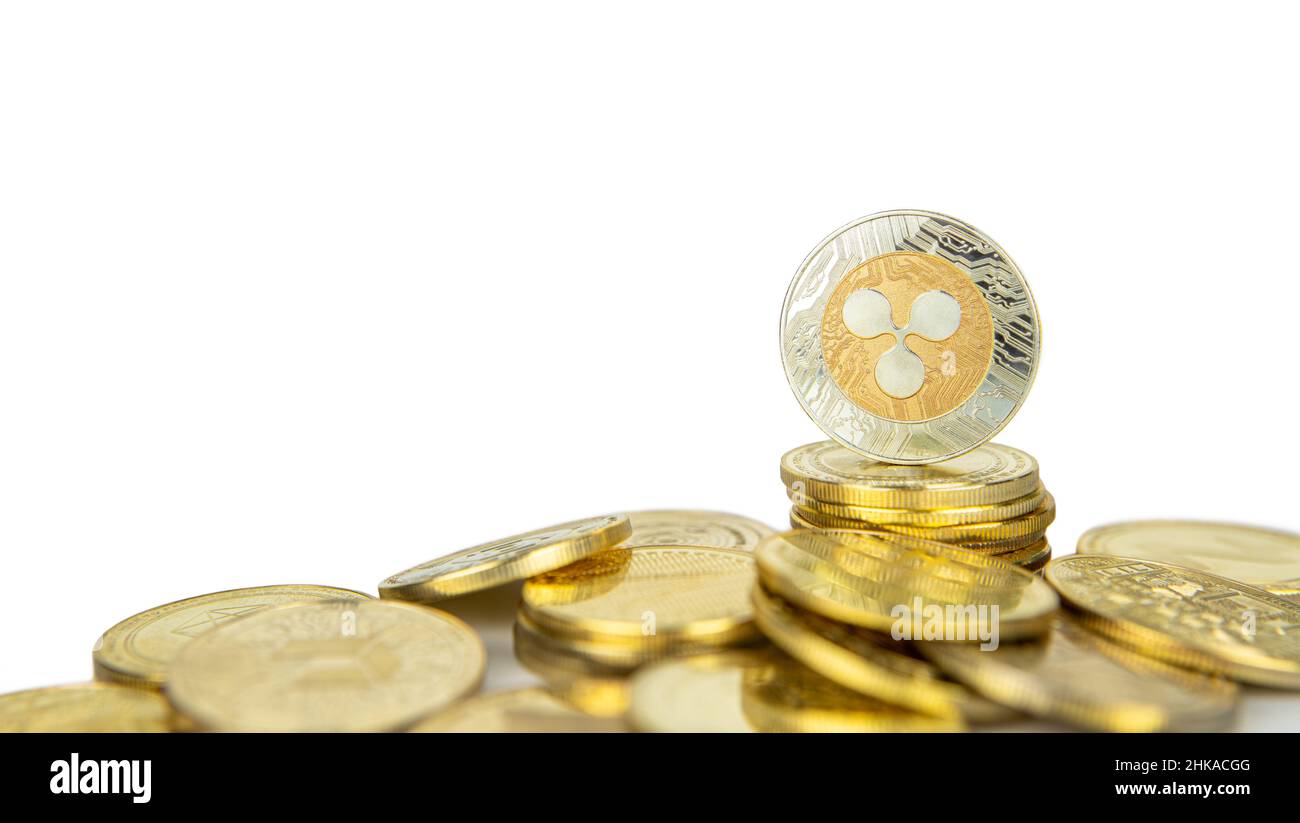 Ripple XRP cryptocurrency standing on pile of gold crypto coins isolated on white background with copy space for text, close-up. Stock Photo