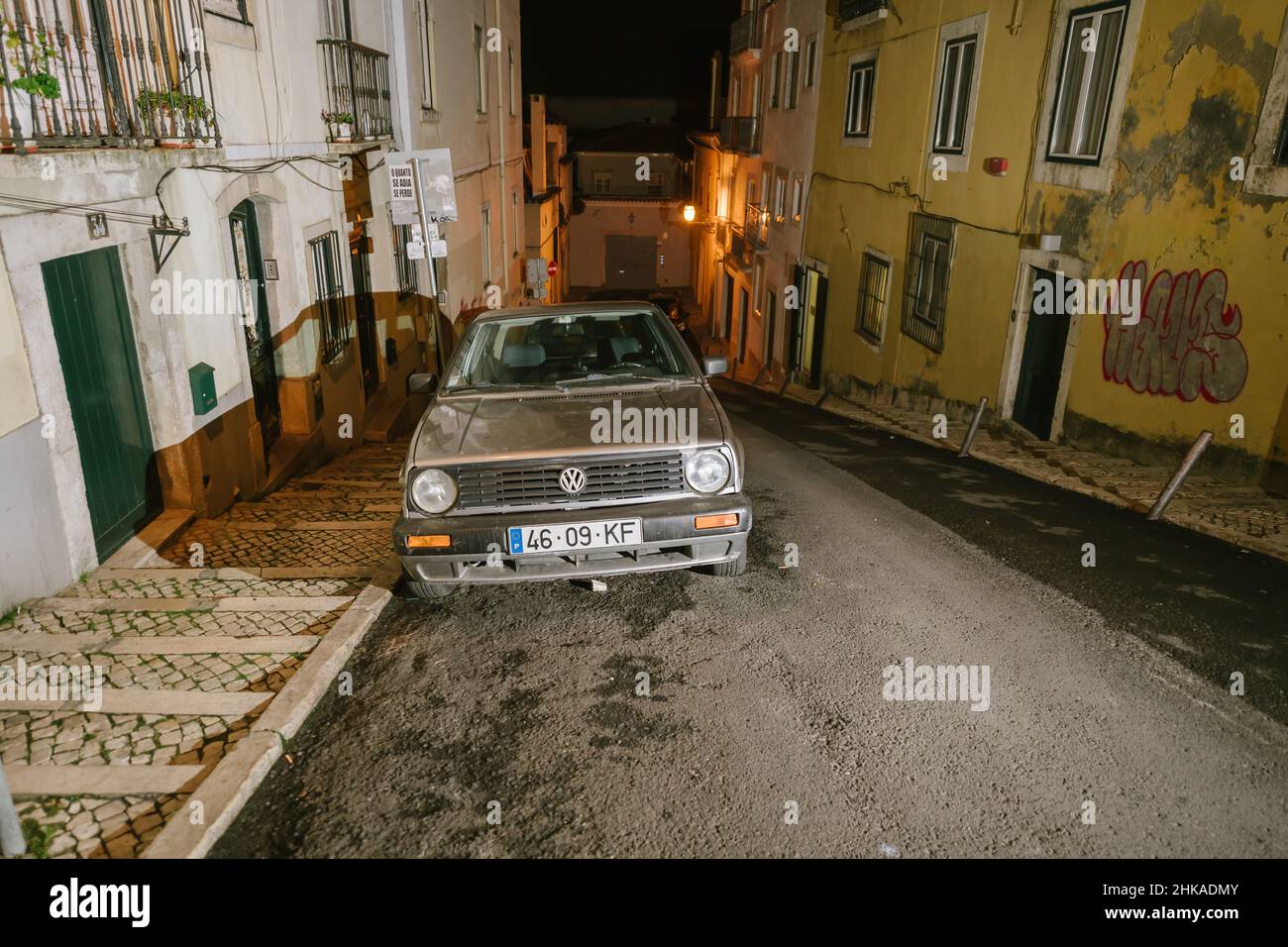 Lisbon, Portugal - Feb 2, 2018: Front view of olf Volskwagen VW diesl Golf car parked on a rusitc old vintage street in central Lisbon - night with long shadows Stock Photo