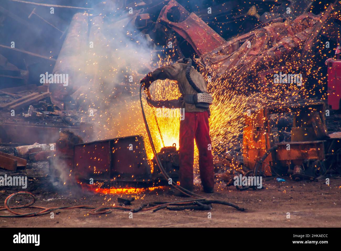 Man cutting scrap steel with a gas cutting torch Stock Photo Alamy