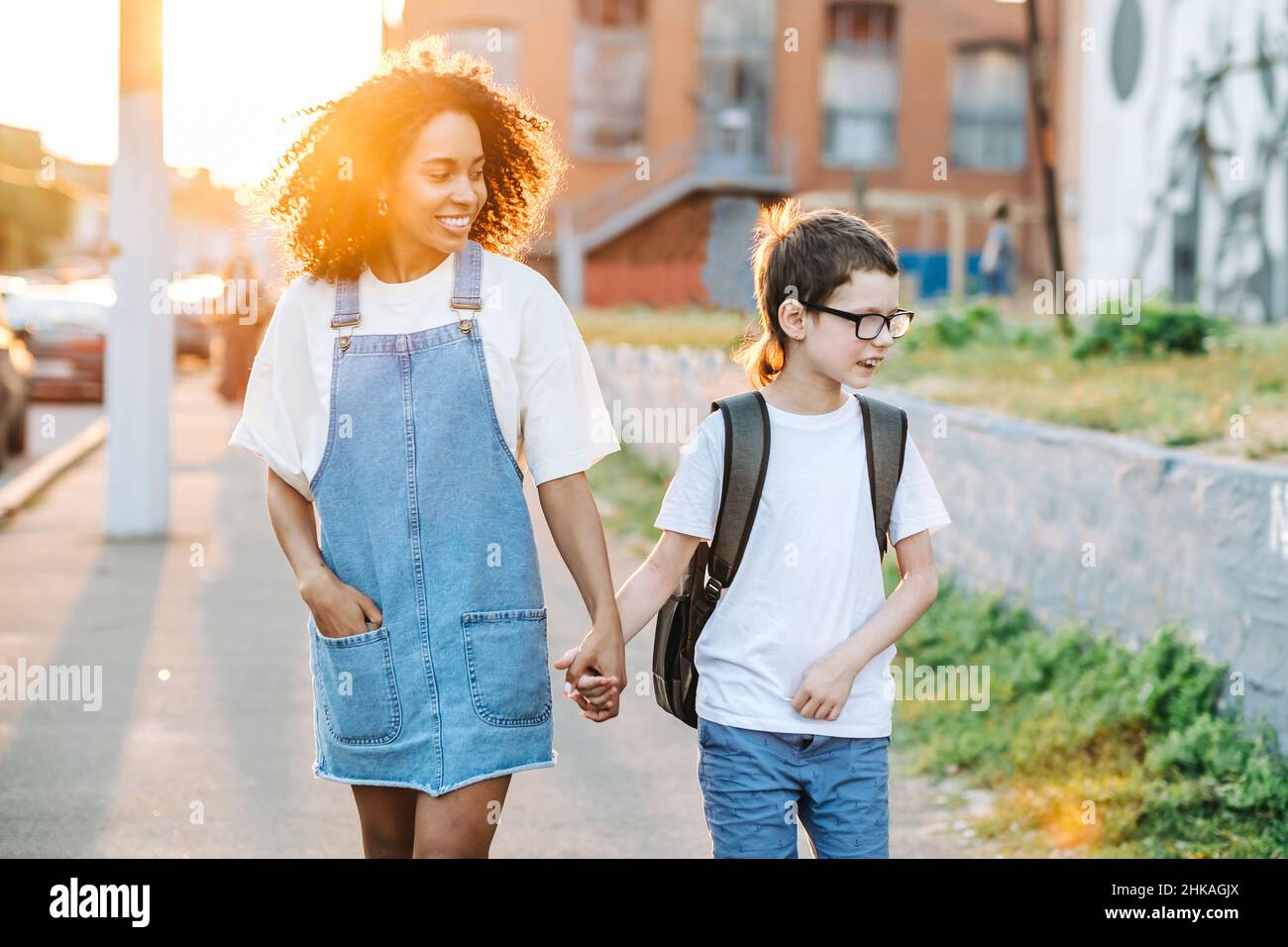 Autism awareness concept. Autistic boy with tutor outsibe while walking