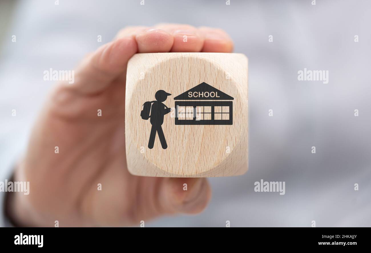 Hand holding a wooden cube with symbol of back to school concept Stock ...