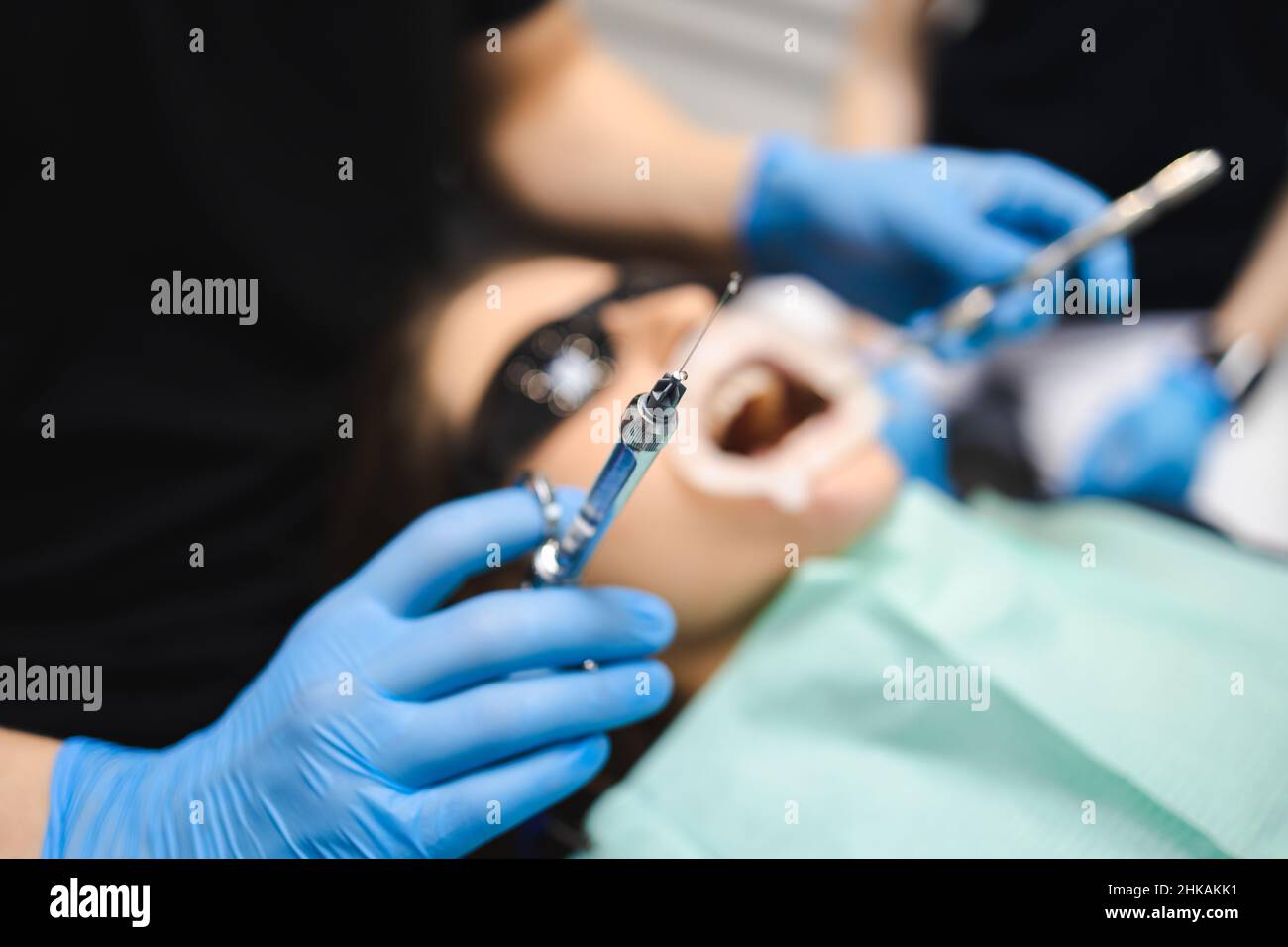 Dentist is going to inject anesthesia to the patient before starting ...
