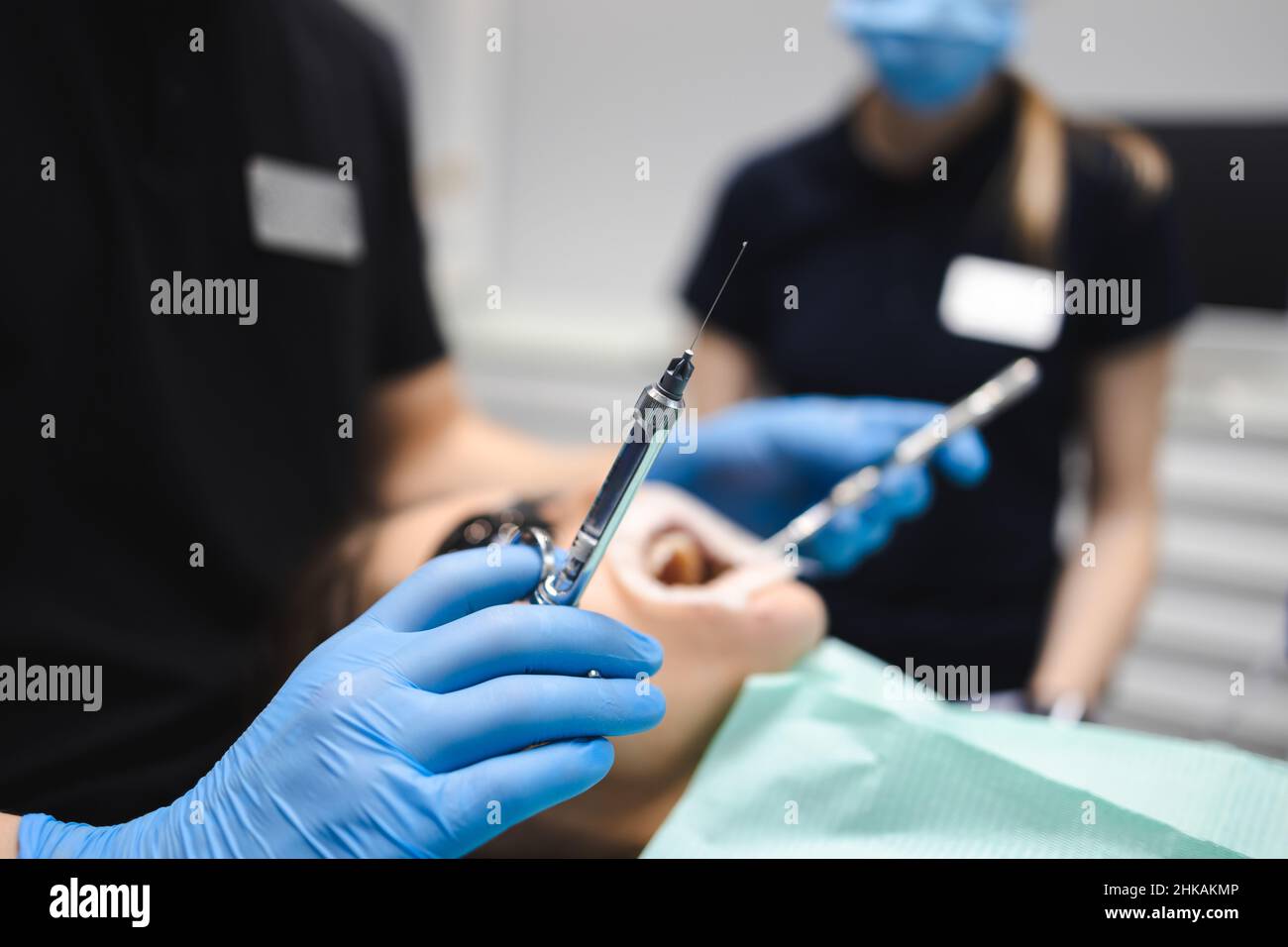 Dentist is going to inject anesthesia to the patient before starting
