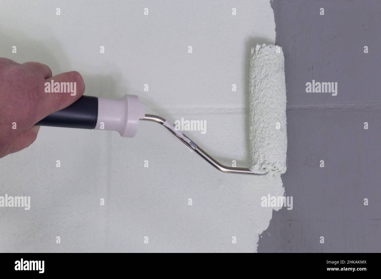 Man painting tiles with a paint roller. Do it yourself concept Stock Photo Alamy