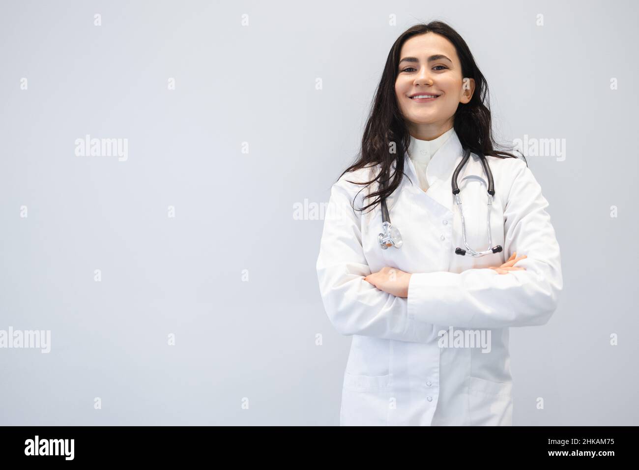 Happy young doctor crossed arms hi-res stock photography and images - Alamy