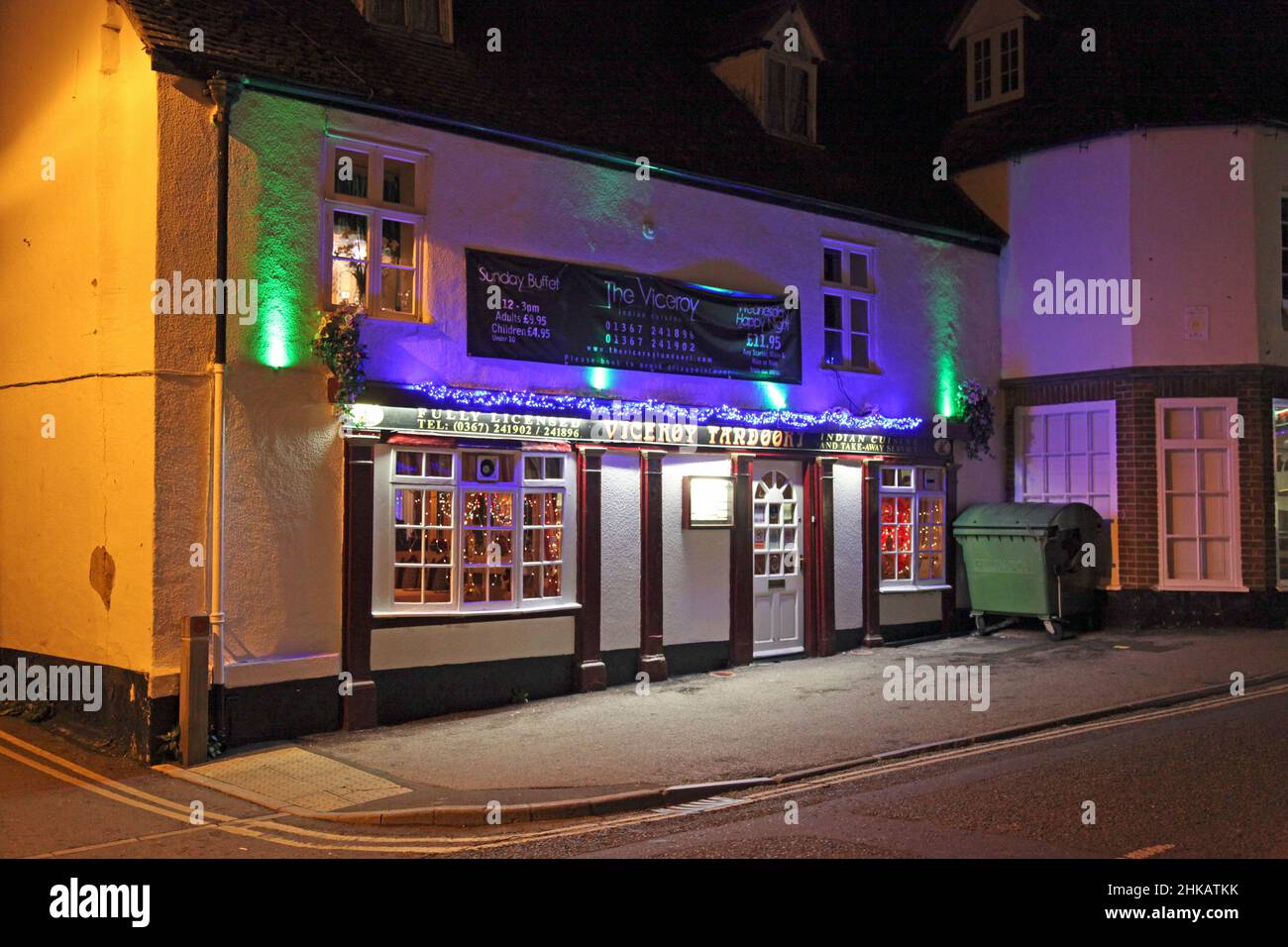 The Viceroy Indian take-away and restaurant at Christmas with colourful lights and an inviting ambiance, for friends, family and the office party! Stock Photo