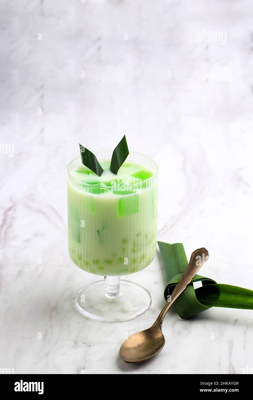Buko Pandan,Philippines Dessert Made from Jelly, Young Coconut, Evaporated Milk, Sweetened Condensed Milk, and Ice. Served in Glass on White Marble Ba Stock Photo