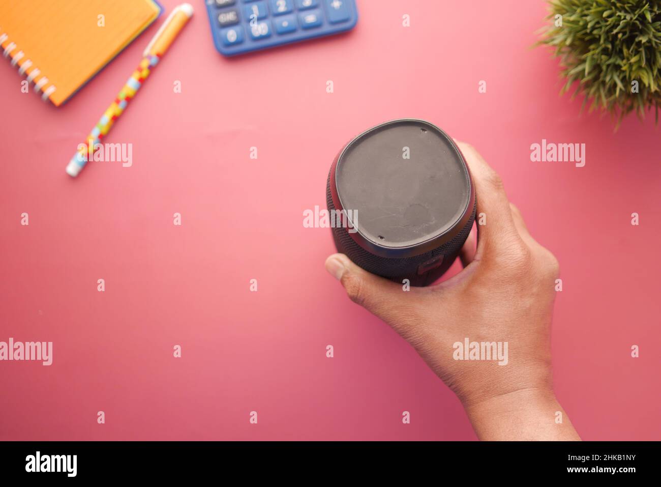 man's hand using smart speaker on table  Stock Photo