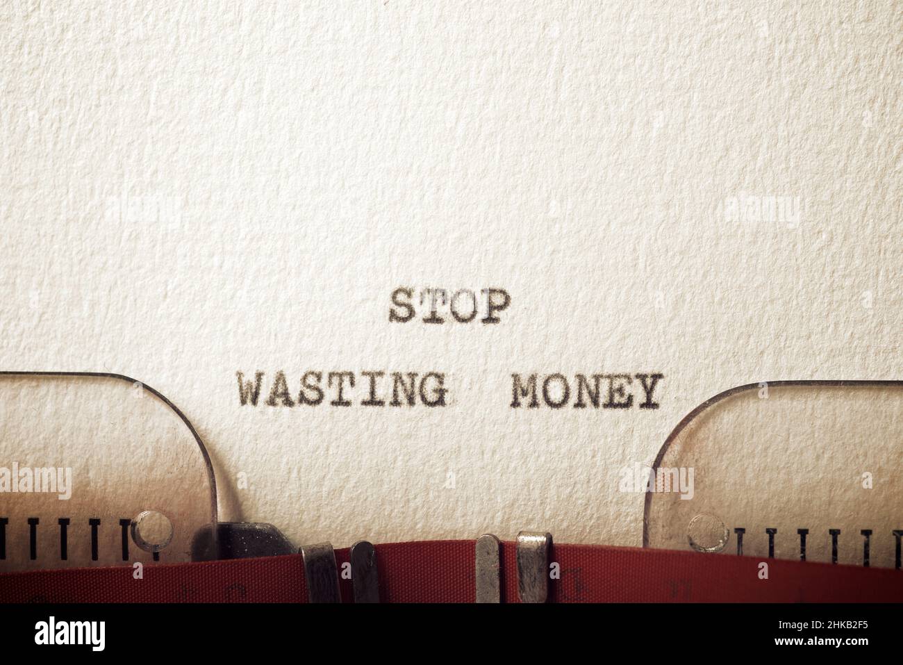 Stop wasting money text written with a typewriter Stock Photo Alamy