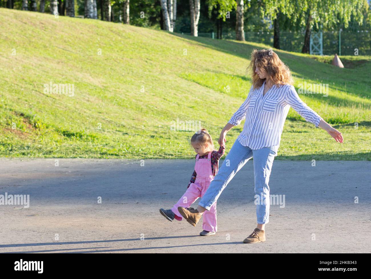 Happy young woman walking on road holding hands Stock Photo - Alamy