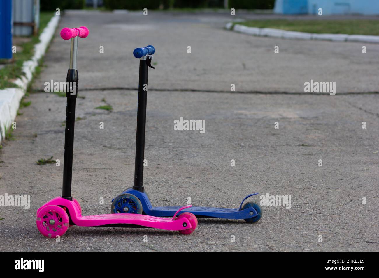 Two scooters pink for girl, blue for boy Stock Photo