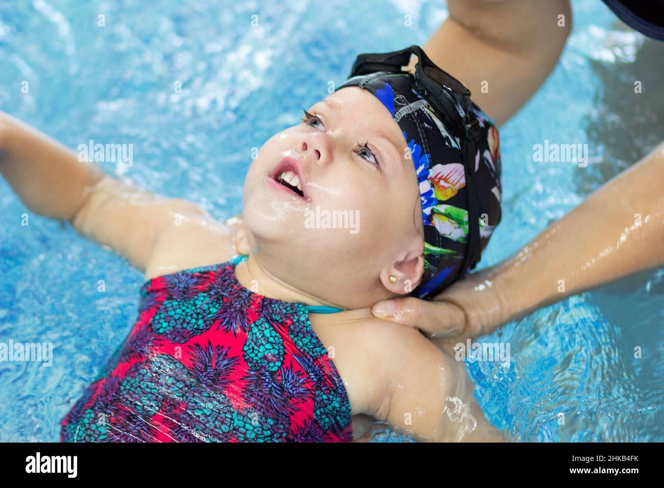 Mother teaching child to float on back in swimming pool Stock Photo Alamy