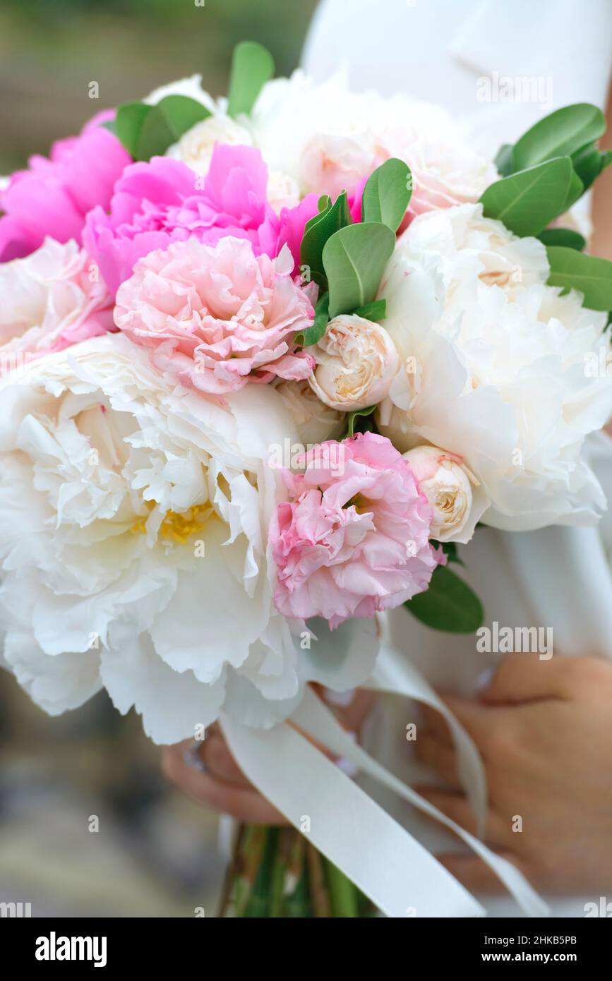 Bride Holding a Bouquet with Peonies Stock Photo - Alamy