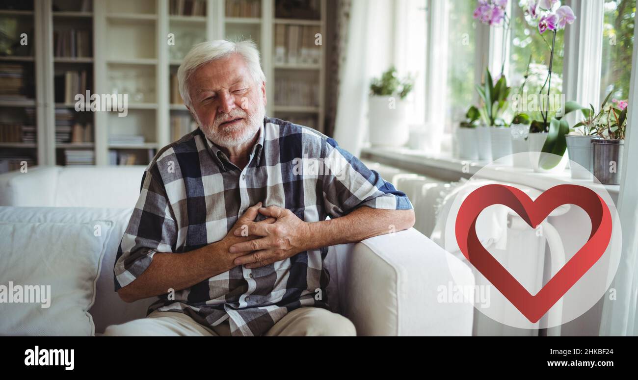 Caucasian senior man with eyes closed and hands on chest suffering from heart pain Stock Photo